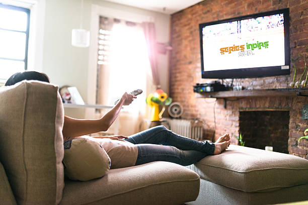 woman relaxing online on sofa reading some papers